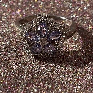 Sterling silver ring with purple and clear stones.